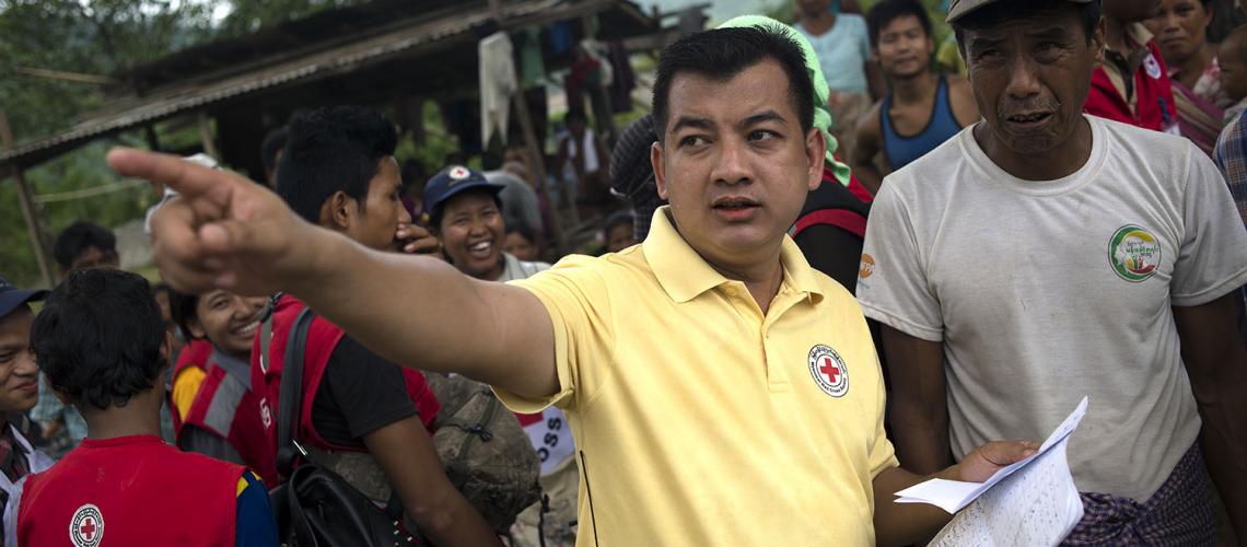 Man in yellow shirt pointing