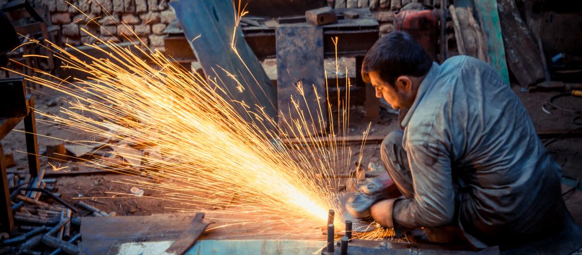 Man using a tool creating sparks