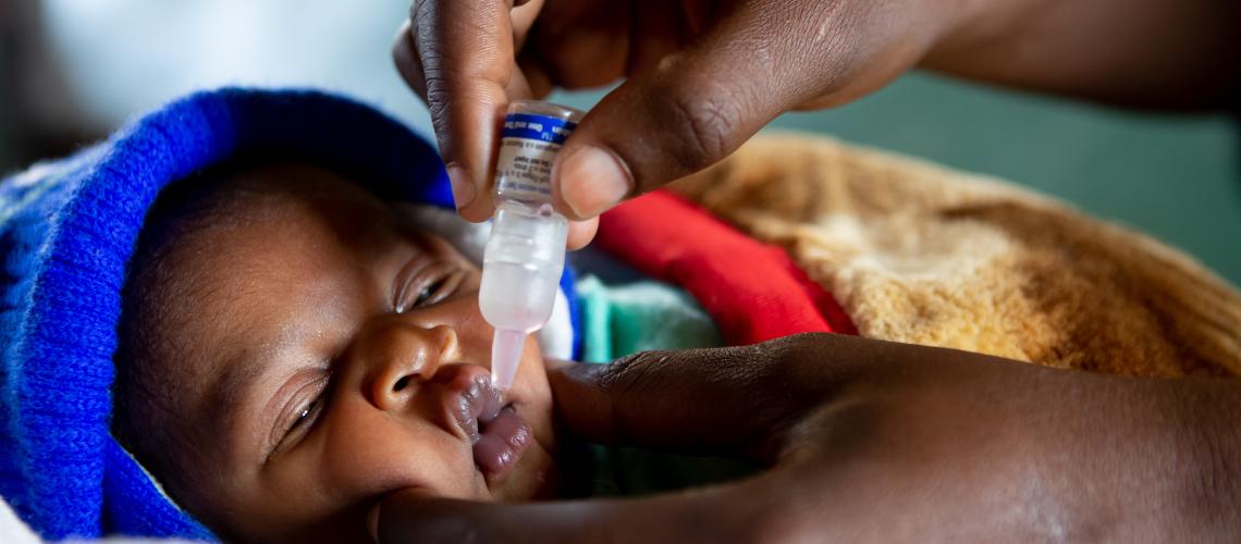 Baby getting administered medicine orally