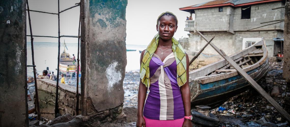 Young woman standing in a flood damaged coastal area