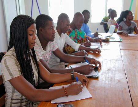 Young men and women sitting at a desk